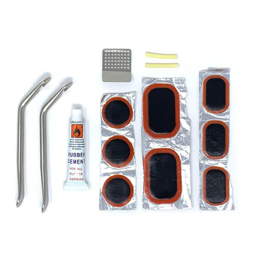 Bakcou Trailside Repair Kit fully laid out, displaying essential bike tools for on-the-go maintenance, including chain tools, multi-tool, pump, and patch kit.