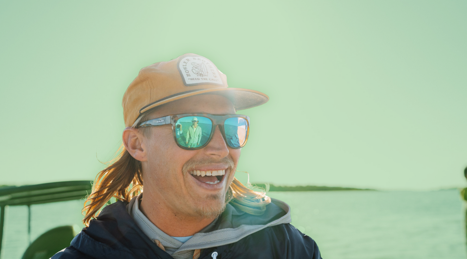 Man wearing Bajío Sunglasses with Green Mirror Lenses while fishing – High-Contrast Polarized Sunglasses for Bright Light