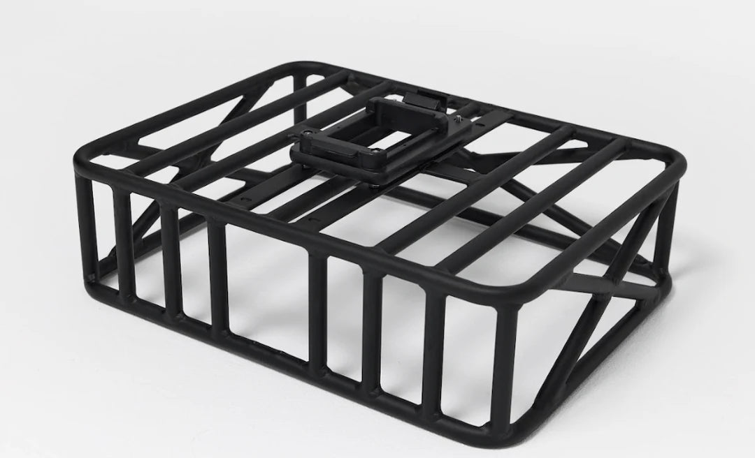 Rear-mounted pannier rack on Bakcou e-bike for secure gear transport during hunting or trail riding